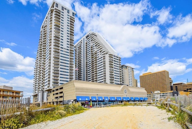 view of property with fence and a city view