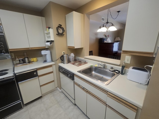 kitchen with pendant lighting, light countertops, white cabinets, a sink, and white dishwasher