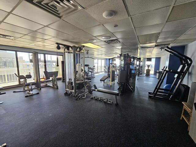 exercise room featuring a drop ceiling and visible vents