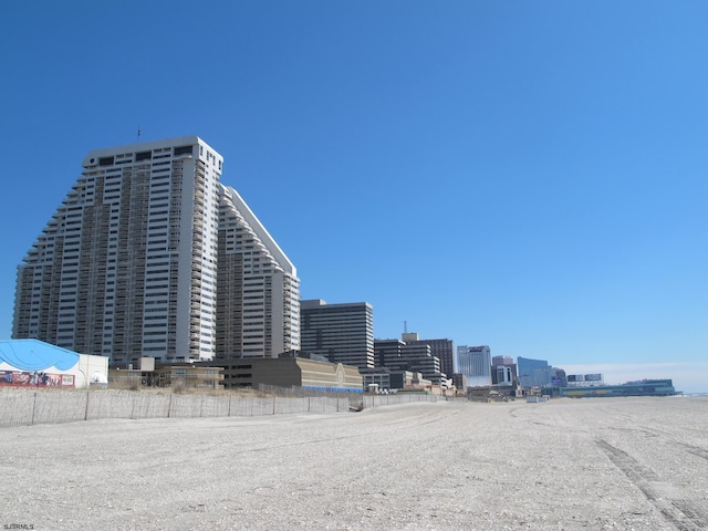 view of building exterior with a view of city and fence
