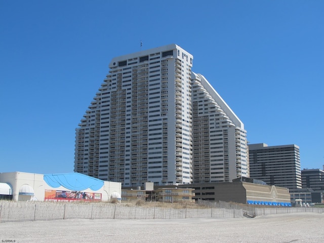 view of property with a view of city and fence