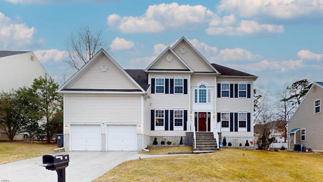 view of front of home featuring an attached garage, concrete driveway, and a front yard