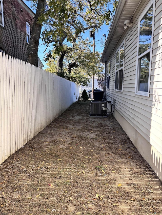 view of yard with cooling unit and fence