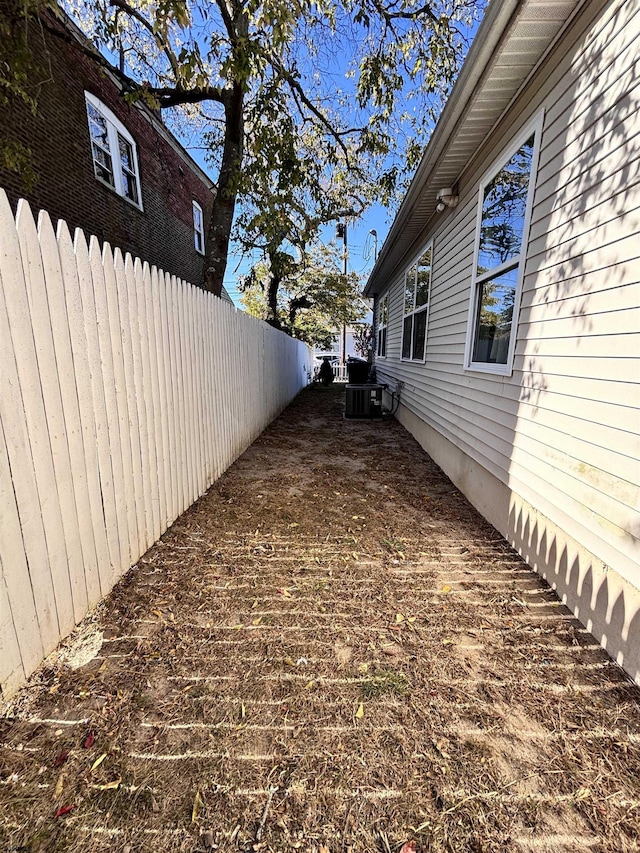 view of home's exterior with fence and central air condition unit