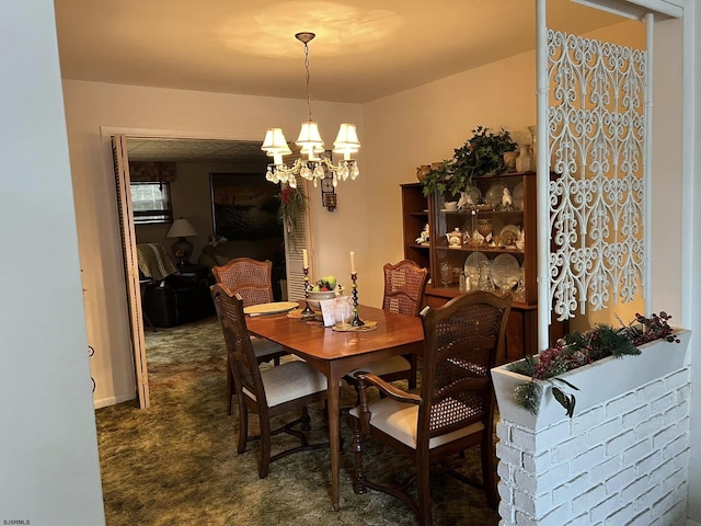 dining area with dark colored carpet and a notable chandelier