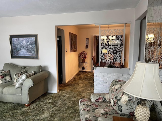 living room featuring dark carpet, baseboards, and an inviting chandelier