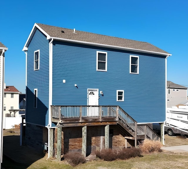 back of house featuring a wooden deck and stairs