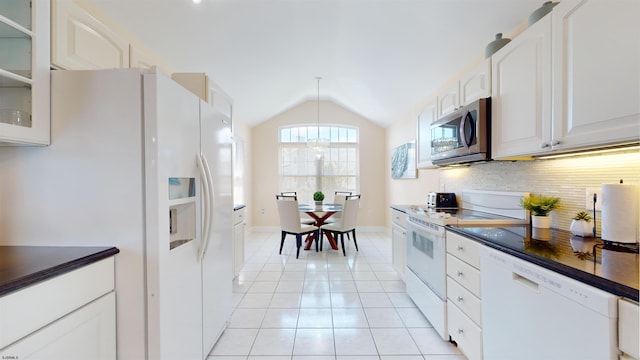 kitchen featuring white appliances, white cabinetry, backsplash, dark countertops, and glass insert cabinets