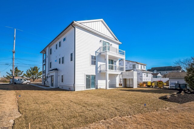 22 Roosevelt, Ocean City, NJ 08226 - back of property with a balcony, a lawn, and board and batten siding