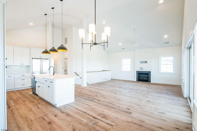 22 Roosevelt, Ocean City, NJ 08226 - kitchen featuring high vaulted ceiling, light wood-style flooring, a sink, white cabinetry, and fridge