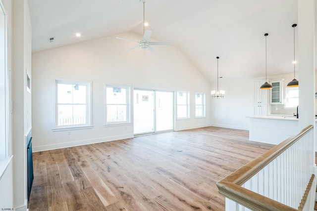 22 Roosevelt, Ocean City, NJ 08226 - unfurnished living room with high vaulted ceiling, light wood-type flooring, plenty of natural light, and ceiling fan with notable chandelier