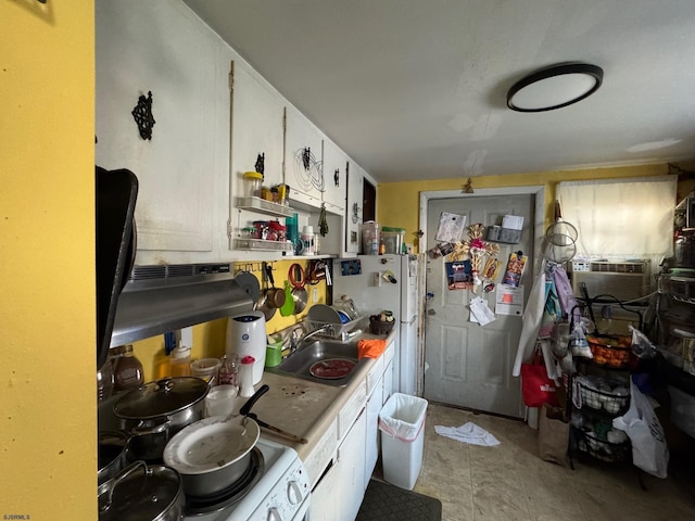 kitchen with cooling unit, white appliances, a sink, white cabinets, and light countertops