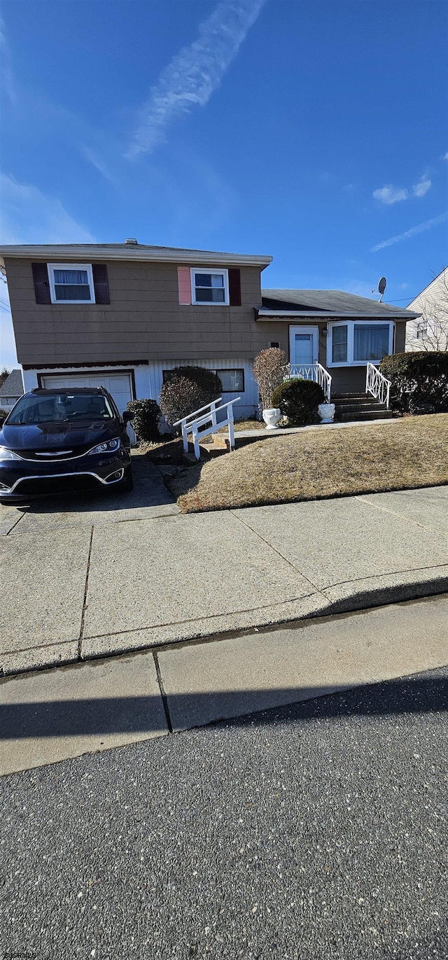 view of front facade with driveway and an attached garage