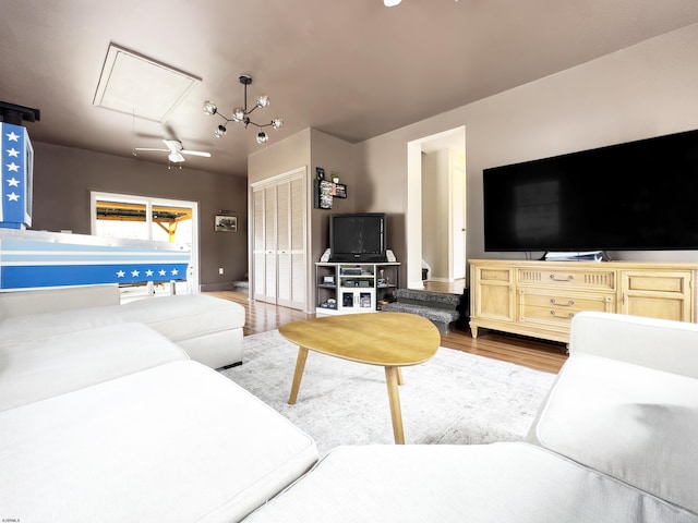 living room featuring attic access and light wood-type flooring