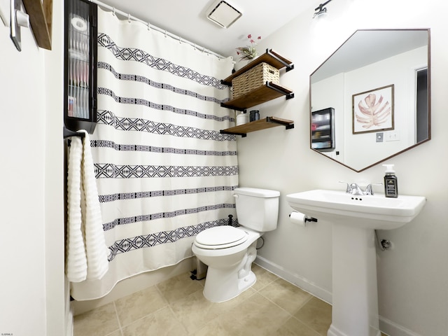 bathroom with toilet, baseboards, a shower with shower curtain, and tile patterned floors