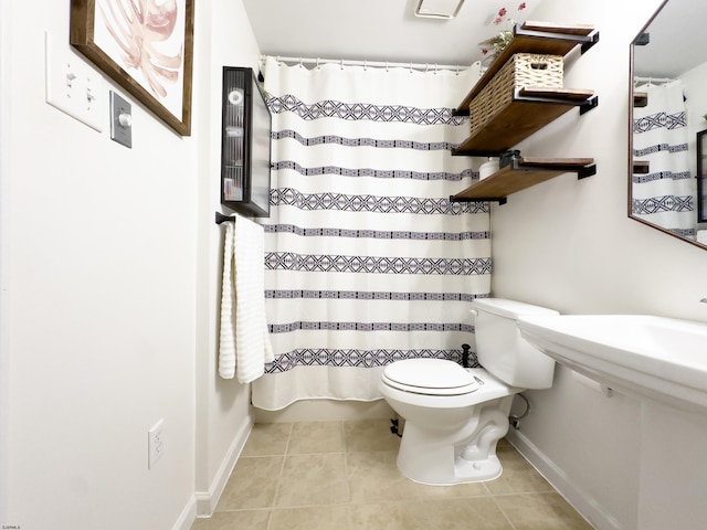 bathroom featuring baseboards, curtained shower, toilet, and tile patterned floors