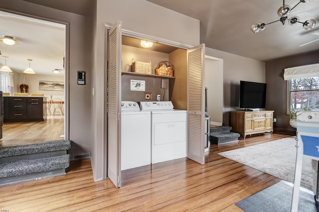 washroom featuring laundry area, light wood-style flooring, and independent washer and dryer