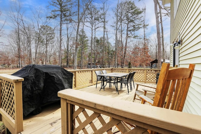 wooden terrace with outdoor dining area