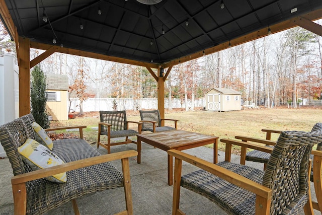 view of patio / terrace featuring a storage shed, a gazebo, an outbuilding, and a fenced backyard