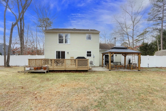 back of house featuring a yard, a fenced backyard, a patio area, and a gazebo