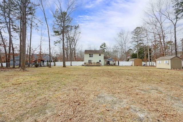 view of yard with an outdoor structure, fence, a gazebo, and a shed