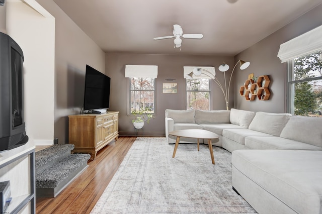 living room featuring light wood-style floors, a wealth of natural light, and ceiling fan