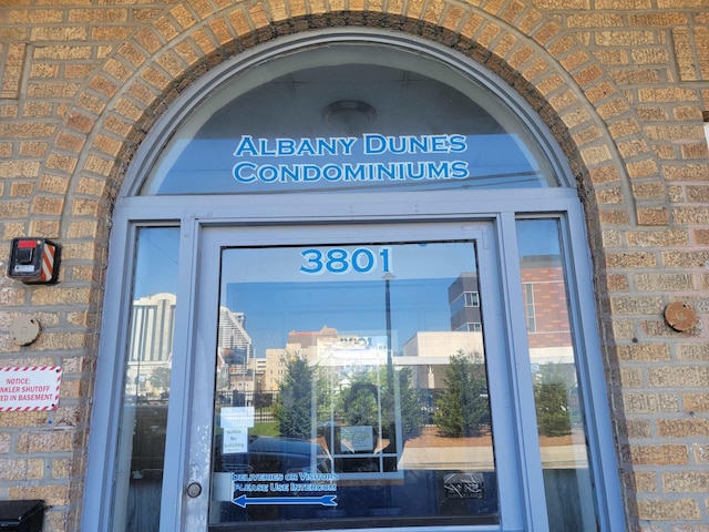 view of exterior entry with brick siding