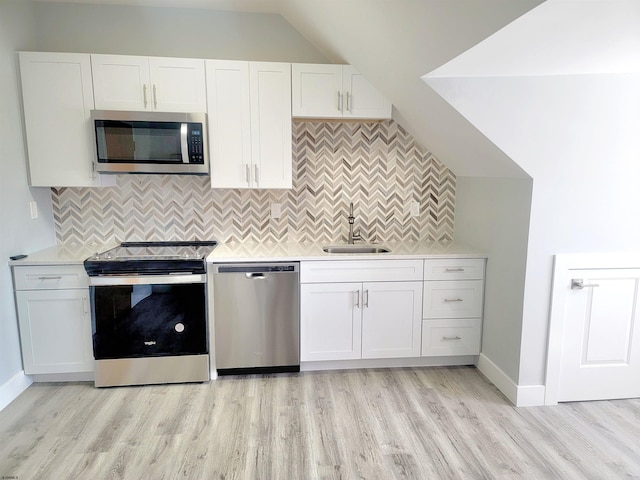 kitchen featuring white cabinetry, stainless steel appliances, and light countertops