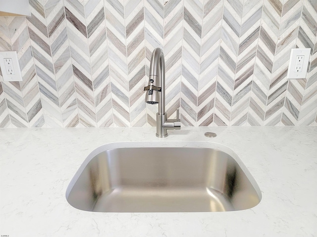 room details with light stone counters and a sink