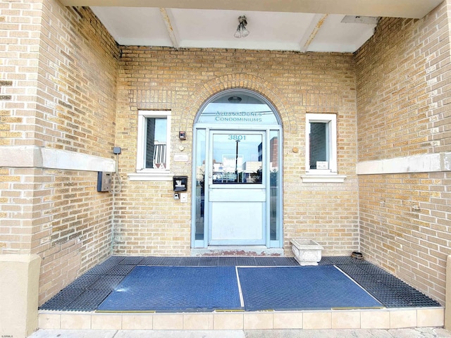 property entrance featuring brick siding