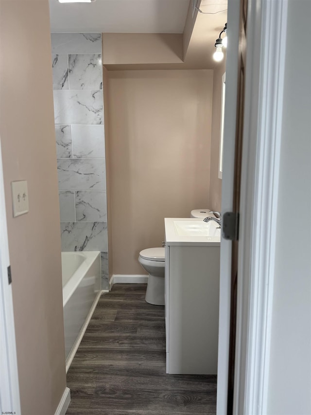 full bathroom with baseboards, vanity, toilet, and wood finished floors