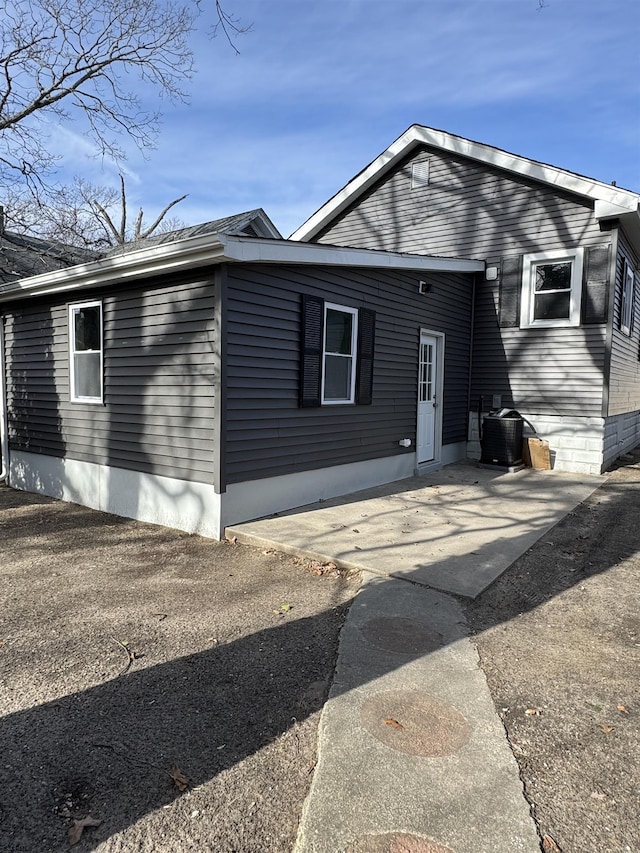 view of front of property with a patio and central air condition unit