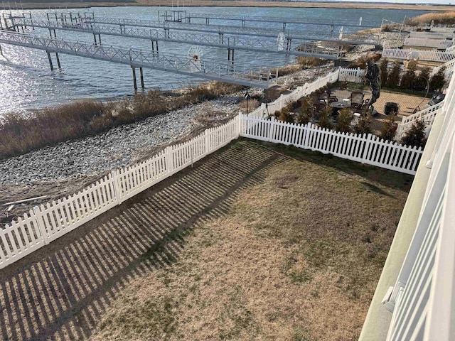 view of yard featuring a water view and fence