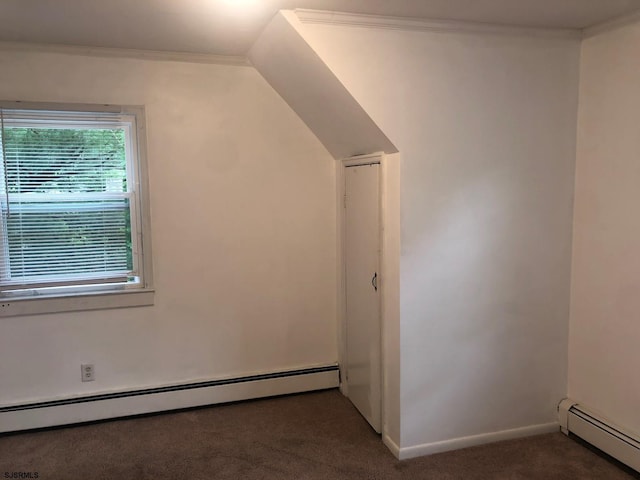 additional living space featuring dark carpet, a baseboard radiator, and baseboards