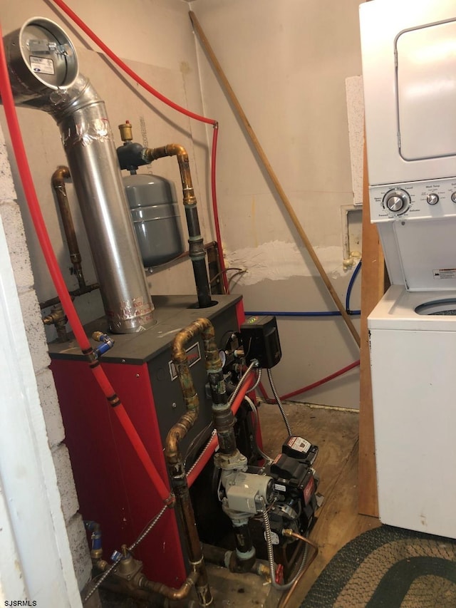 utility room featuring stacked washer and clothes dryer