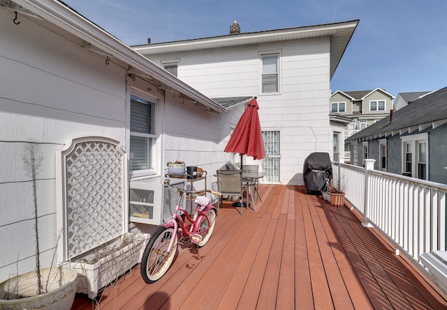 deck featuring a grill and outdoor dining space