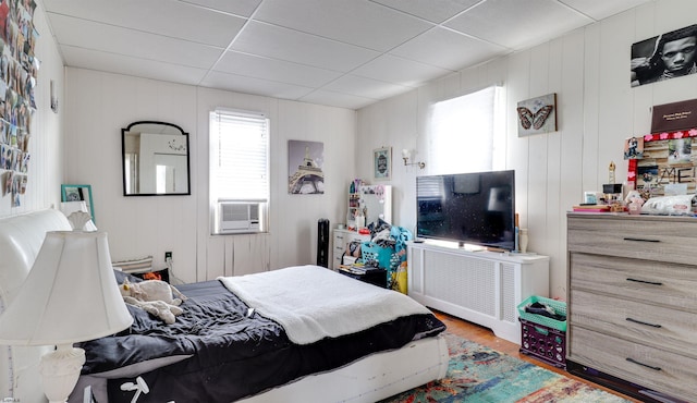 bedroom featuring cooling unit and wood finished floors