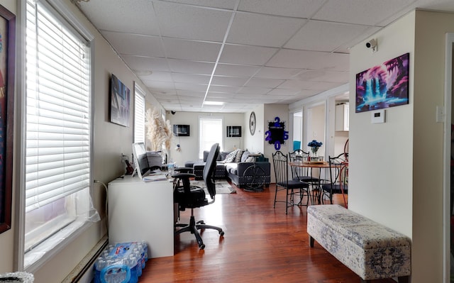 office with a paneled ceiling and wood finished floors