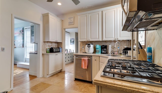 kitchen featuring white cabinets, a sink, stainless steel appliances, and light countertops