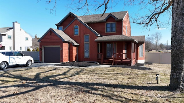 view of front facade featuring a garage, a shingled roof, fence, and a porch