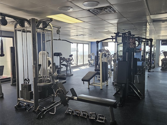 workout area with a paneled ceiling and visible vents