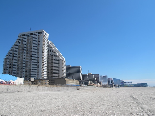 view of property featuring fence and a city view