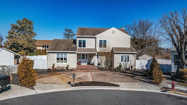 view of front of property with a shingled roof, fence, and a chimney