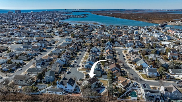 birds eye view of property with a residential view and a water view