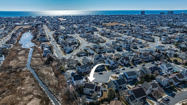 bird's eye view featuring a water view and a residential view