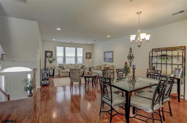 dining room featuring an inviting chandelier, visible vents, wood finished floors, and recessed lighting