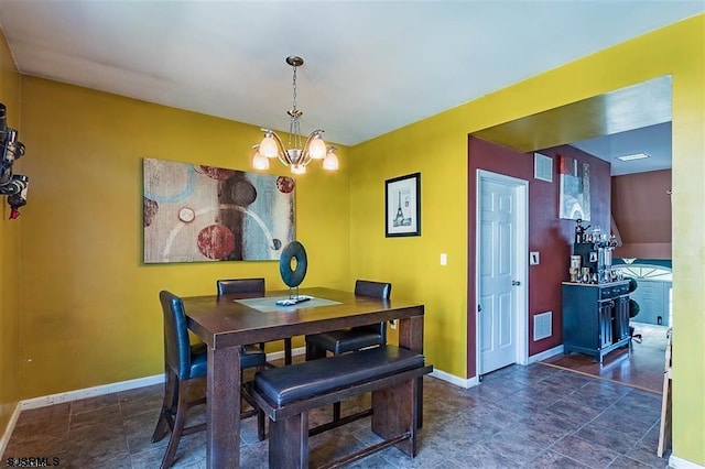 dining area with visible vents, baseboards, and an inviting chandelier