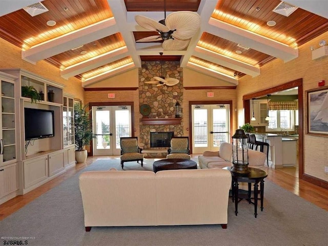 living room with wood ceiling, french doors, beamed ceiling, and visible vents