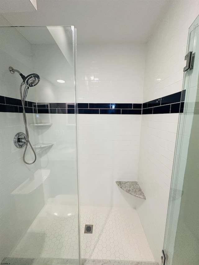 full bathroom featuring a stall shower and tile patterned flooring