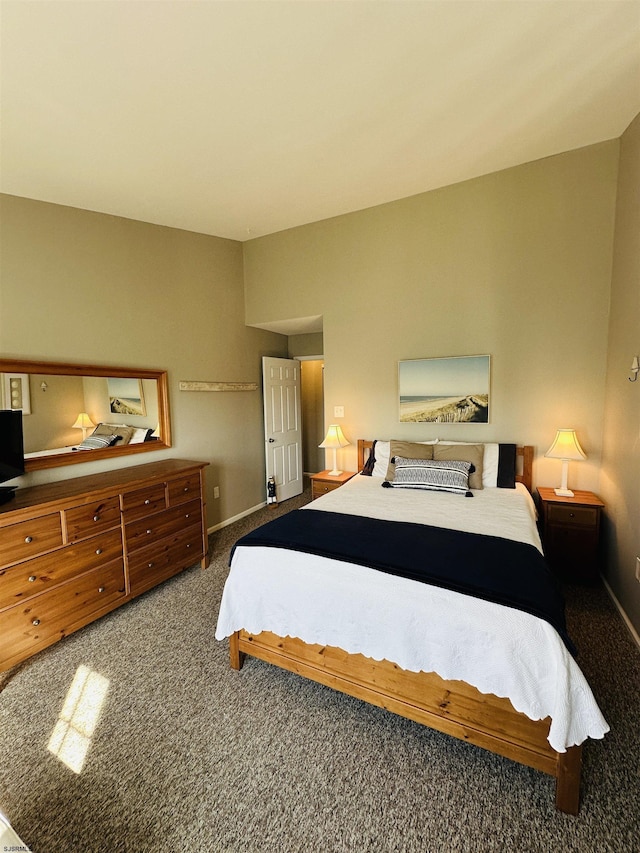 carpeted bedroom featuring baseboards